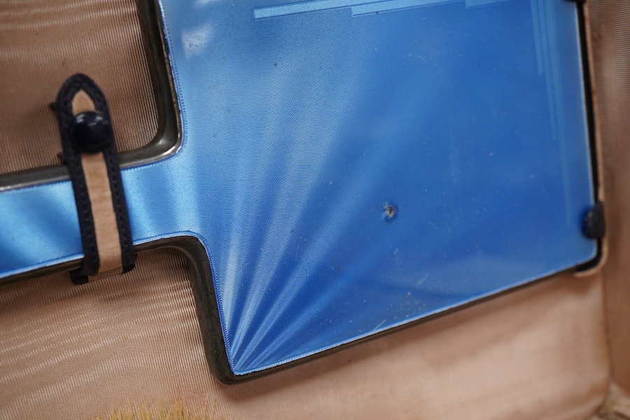 A George V/George VI Art Deco vanity case containing nine silver and blue guilloche enamel mounted items including a hand mirror, brushes, nail implement etc. Walker & Hall, 1936/37, incomplete.